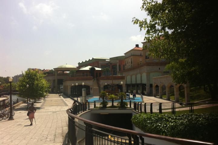 An old woman walking on the riverside