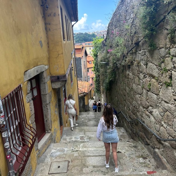 a person standing next to a stone wall