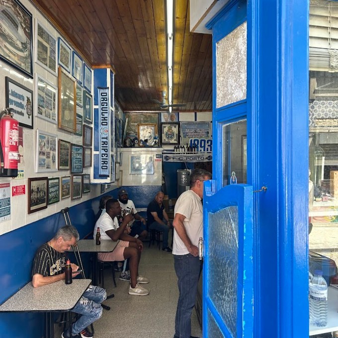 a group of people standing in front of a store